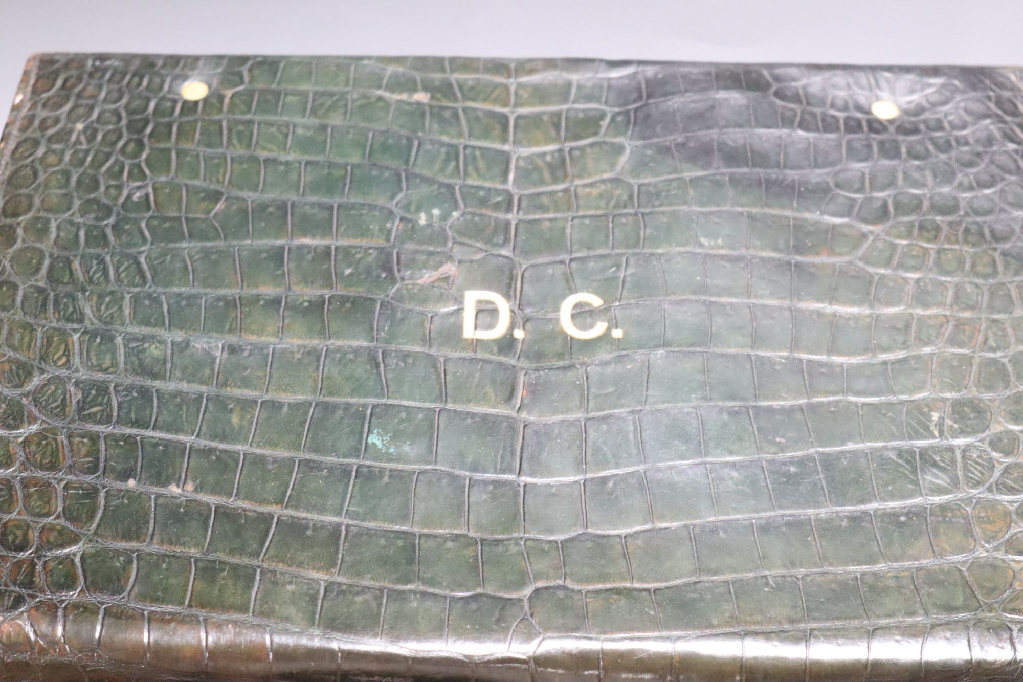 A crocodile skin travelling toilet case and contents